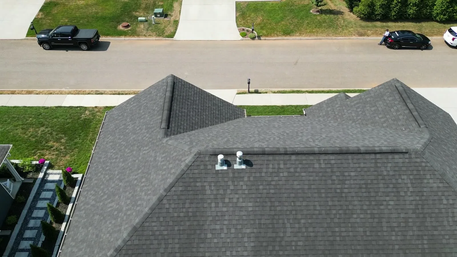 Drone view of a home with an asphalt shingle roof in an Arizona suburb