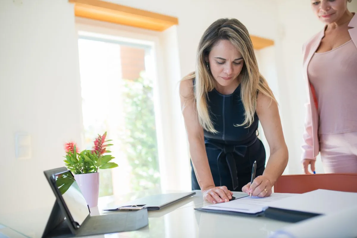Property manager standing in front of a portfolio of managed homes
